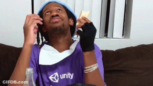 A Man Wearing A Purple Shirt That Says Unity Is Sitting On A Couch GIF