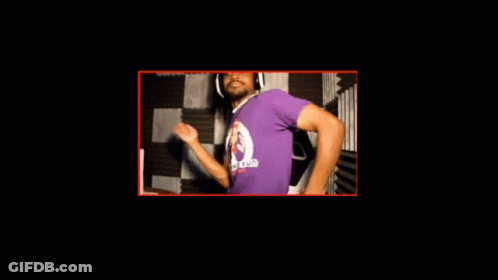 A Man Wearing A Purple Shirt With A Monkey On It Dancing GIF