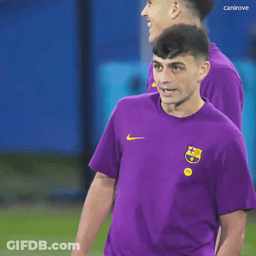 A Man Wearing A Purple Shirt With A Nike Logo On The Front GIF