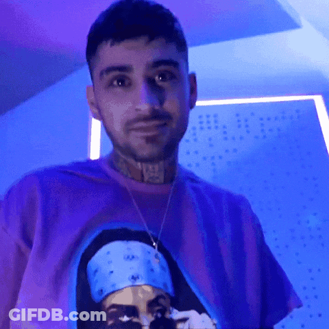 A Man Wearing A Purple Shirt With A Picture On It GIF