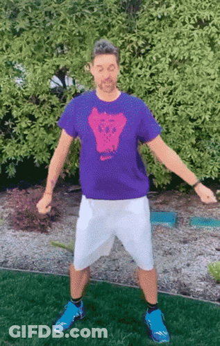 A Man Wearing A Purple Shirt With A Skull On The Front GIF