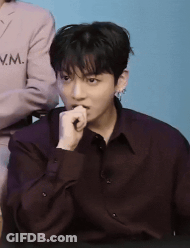 A Man Wearing A Purple Shirt With The Letter Vm On The Front GIF