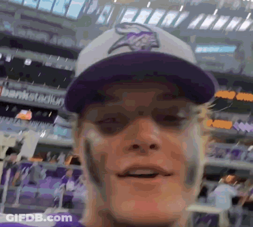 A Man Wearing A Purple Vikings Hat And A Purple Jersey GIF