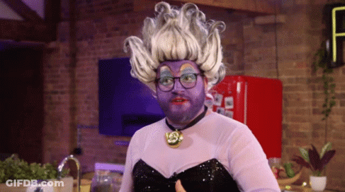 A Man Wearing A Purple Wig And Glasses Giving A Thumbs Up GIF