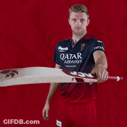A Man Wearing A Qatar Airways Jersey Holds A Bat GIF