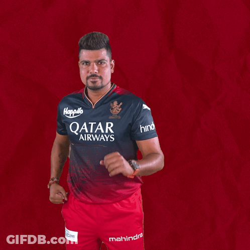 A Man Wearing A Qatar Airways Shirt And Mahindra Shorts GIF