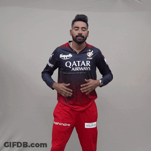 A Man Wearing A Qatar Airways Shirt Holds His Hands To His Chest GIF
