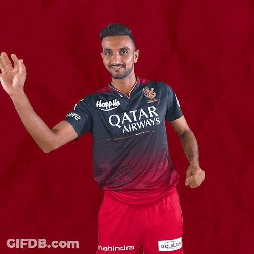 A Man Wearing A Qatar Airways Shirt Is Waving His Hand GIF