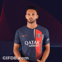 A Man Wearing A Qatar Airways Shirt Stands In Front Of A Blue And Red Background GIF
