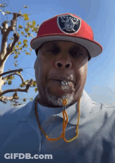 A Man Wearing A Raiders Hat And A Whistle GIF