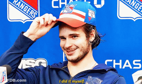 A Man Wearing A Rangers Hat And A Chase Jacket GIF