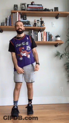 A Man Wearing A Raptors Jersey And Shorts GIF