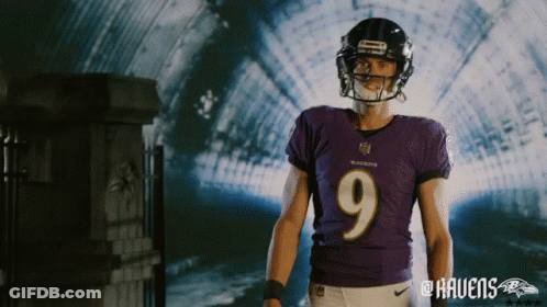 A Man Wearing A Ravens Jersey And Helmet Stands In A Tunnel GIF