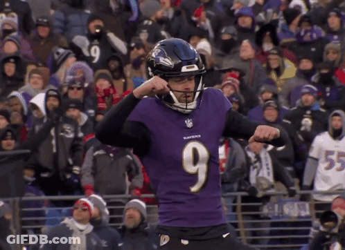 A Man Wearing A Ravens Jersey Is Kicking A Ball GIF