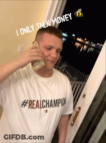 A Man Wearing A #Real Champion Shirt Is Talking On A Phone GIF