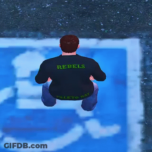 A Man Wearing A Rebels Shirt Is Squatting Down In Front Of A Handicapped Sign GIF