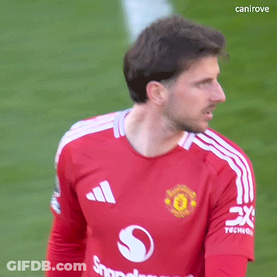 A Man Wearing A Red Adidas Shirt Is Standing On A Green Field . GIF