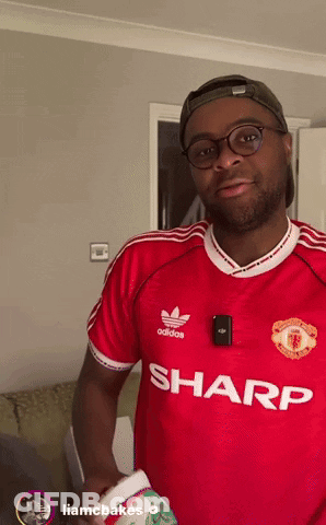 A Man Wearing A Red Adidas Shirt With Sharp Written On The Front GIF