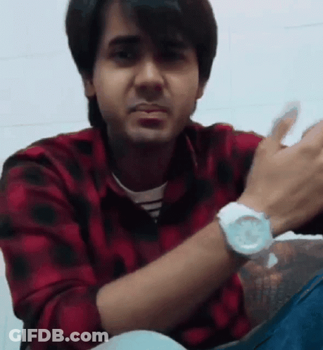 A Man Wearing A Red And Black Plaid Shirt And A White Watch Is Clapping His Hands GIF