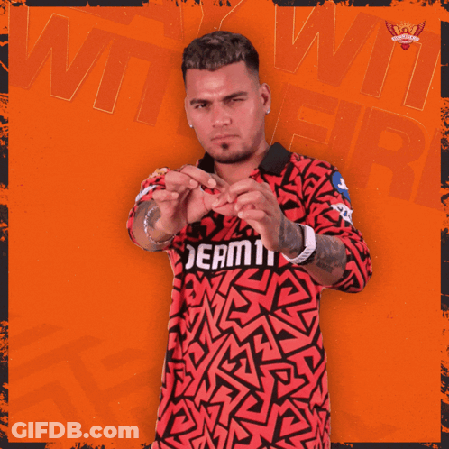 A Man Wearing A Red And Black Shirt That Says Dream11 On It GIF