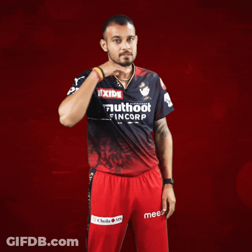 A Man Wearing A Red And Black Shirt That Says Exide On It GIF
