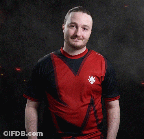 A Man Wearing A Red And Black Shirt With A Crown On The Front GIF