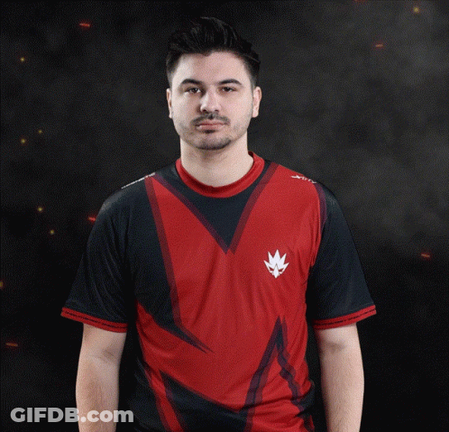 A Man Wearing A Red And Black Shirt With A White X On The Sleeve GIF
