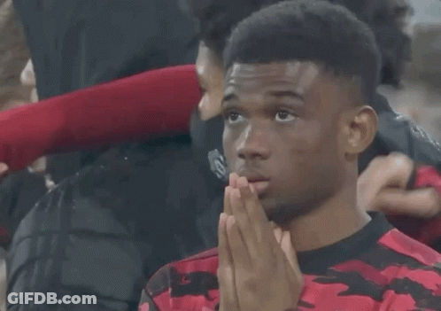 A Man Wearing A Red And Black Shirt With The Number 19 On The Front GIF