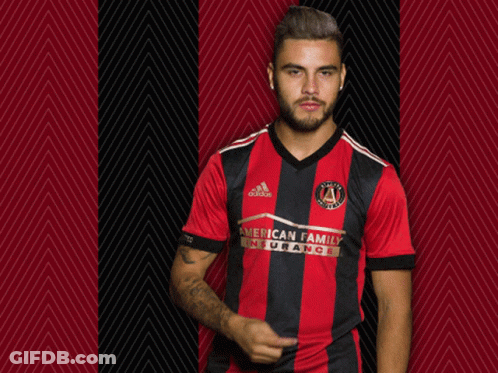 A Man Wearing A Red And Black Striped Shirt That Says American Family Insurance GIF