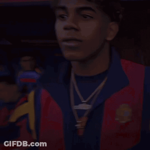 A Man Wearing A Red And Blue Jacket With A Gold Necklace Around His Neck GIF