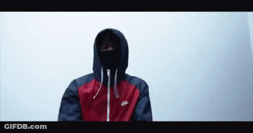 A Man Wearing A Red And Blue Nike Jacket With A Mask On His Face GIF