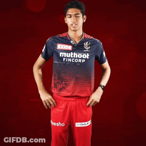A Man Wearing A Red And Blue Shirt That Says Exide Muthoot Fincorp GIF