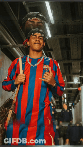 A Man Wearing A Red And Blue Striped Shirt With A Fcb Logo On It GIF