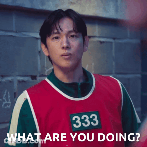 A Man Wearing A Red And Green Vest With The Number 333 On It Says What Are You Doing GIF