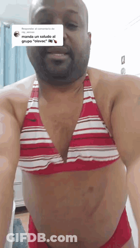 A Man Wearing A Red And White Bikini Top GIF