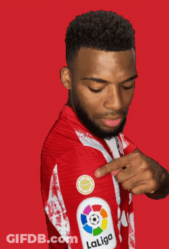 A Man Wearing A Red And White Laliga Jersey Points At His Arm GIF