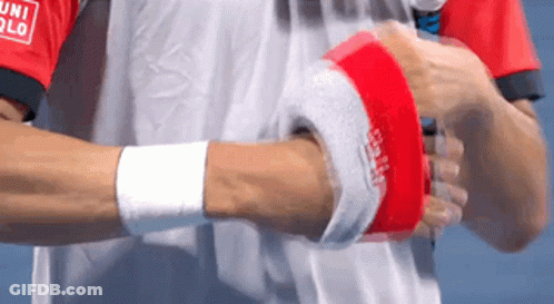 A Man Wearing A Red And White Shirt That Says Uniqlo On The Sleeve GIF
