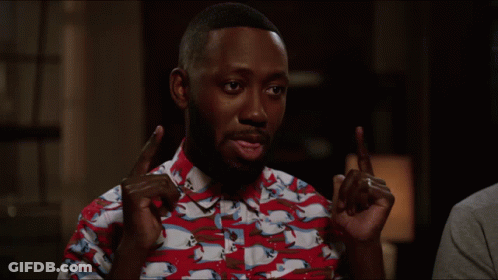A Man Wearing A Red And White Shirt With Horses On It Is Pointing GIF