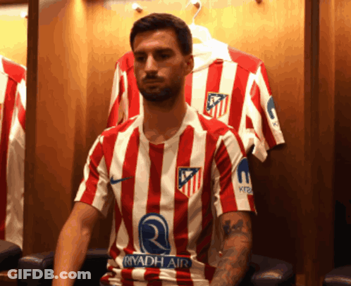 A Man Wearing A Red And White Striped Shirt With The Word Riyadh Air On The Sleeve GIF