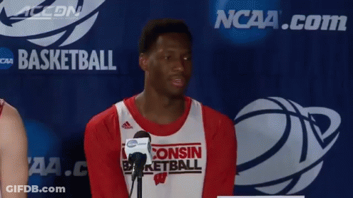 Man In Wisconsin Basketball Jersey With Microphone GIF