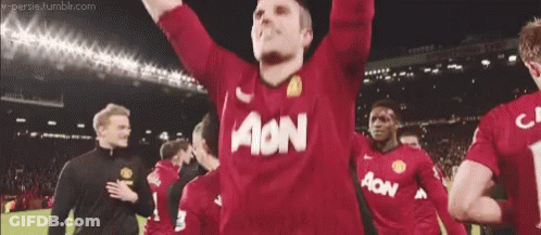A Man Wearing A Red Aon Jersey Holds His Arms Up GIF