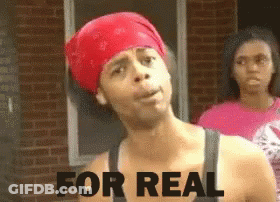 A Man Wearing A Red Bandana Has The Words For Real Written On His Chest GIF