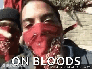 A Man Wearing A Red Bandana On His Face Is Standing Next To Another Man . GIF