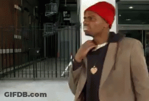 A Man Wearing A Red Beanie And A Brown Jacket GIF