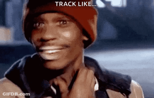 A Man Wearing A Red Beanie And A Jacket Is Smiling And Holding His Neck . GIF