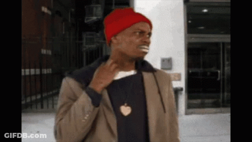 A Man Wearing A Red Beanie And A Necklace With An Apple Pendant GIF