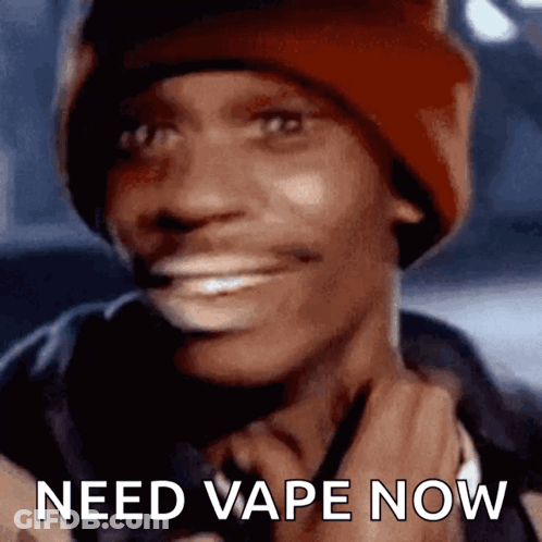 A Man Wearing A Red Beanie Is Smiling With The Words Need Vape Now Below Him GIF