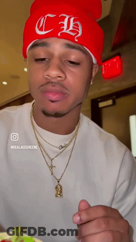 A Man Wearing A Red Beanie With Ch Embroidered On It GIF