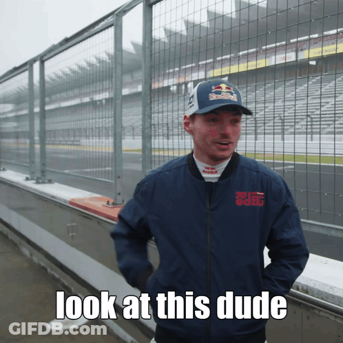A Man Wearing A Red Bull Hat And A Blue Jacket Says " Look At This Dude " GIF