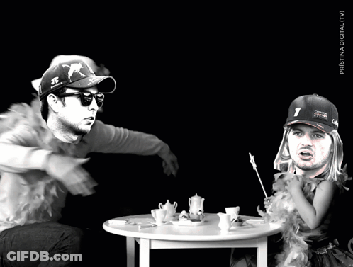 A Man Wearing A Red Bull Hat Sits At A Table GIF